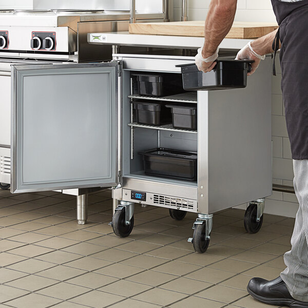 A man opening a Beverage-Air undercounter freezer.