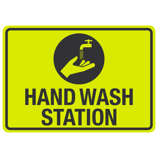 A yellow and black sign with a hand and a faucet that says "Hand Wash Station"