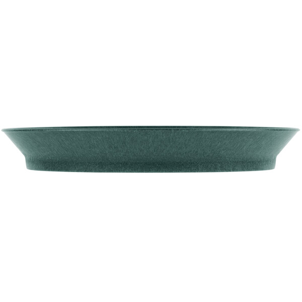 A green HS Inc. polypropylene oval deli server with a rim on a table in a salad bar.