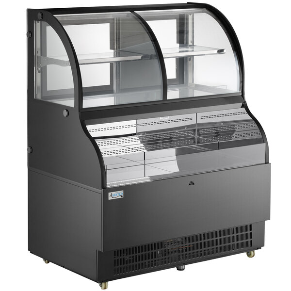 An Avantco black refrigerated air curtain display case with glass doors on a bakery counter.