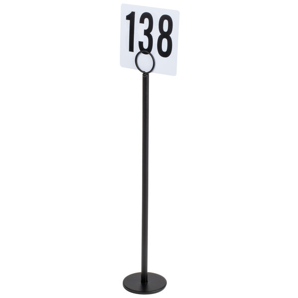 A Tablecraft black flat bottom menu holder with a white sign and black numbers on a table.
