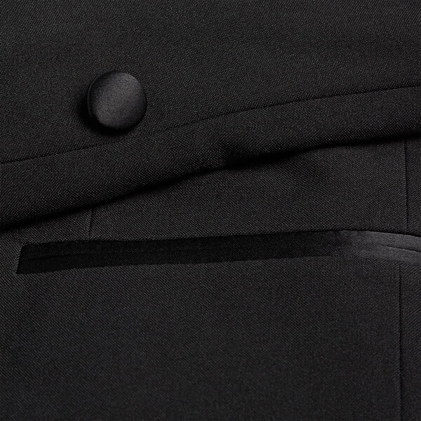 A close up of a button on a Henry Segal black tuxedo jacket.