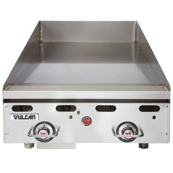A Vulcan commercial gas griddle with a chrome top on a counter.