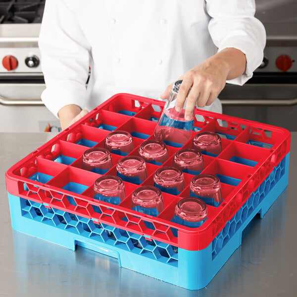 A woman pouring liquid into a clear glass in a red Carlisle glass rack on a red and blue surface.