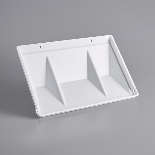 A white plastic shelf with three triangular shapes.