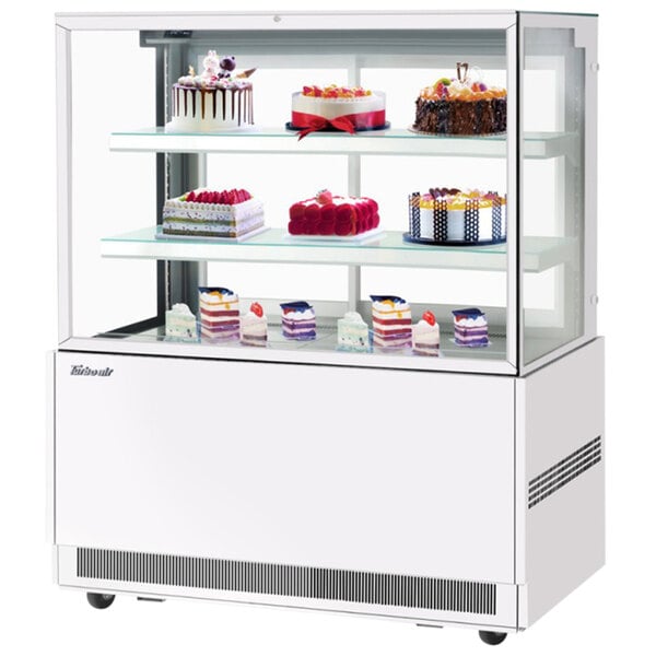 A white Turbo Air refrigerated bakery display case filled with cakes.