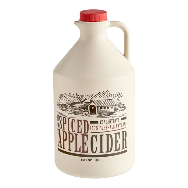 A large cream-colored jug with a red cap and a handle, labeled 'Spiced Apple Cider' with an illustration of a barn and fields.