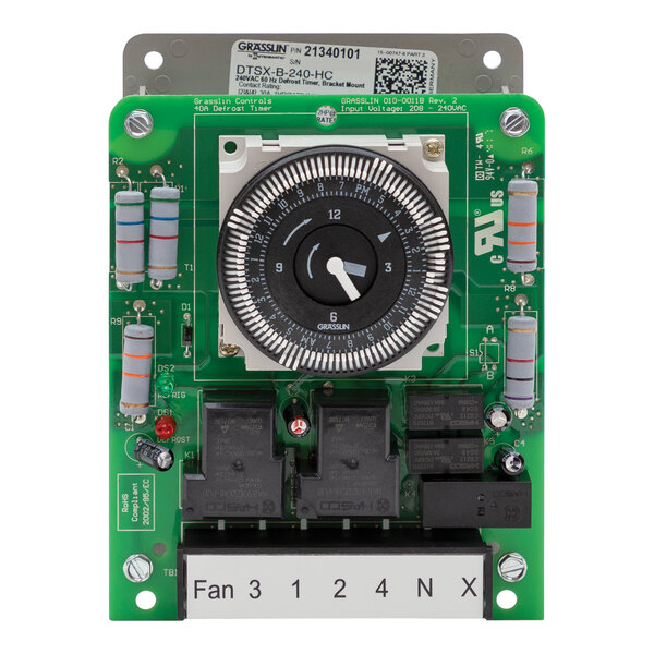 A green circuit board with a Heatcraft electric timer dial and buttons.