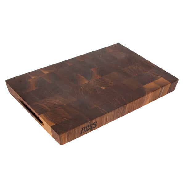 A John Boos black walnut cutting board with hand grips.