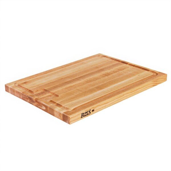 A John Boos maple wood cutting board with hand grips.