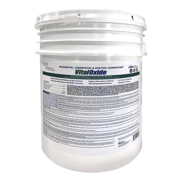 A large white plastic bucket with a detailed product label, featuring the brand name 'Vital Oxide' and information about its use as a disinfectant.