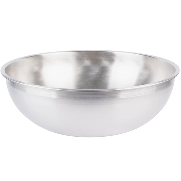 A silver stainless steel Vollrath mixing bowl.