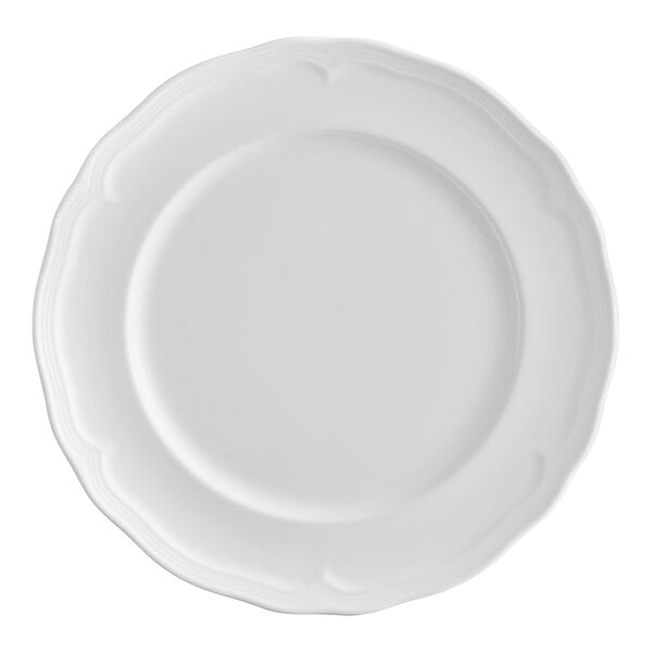 A white porcelain plate with a scalloped wide rim.