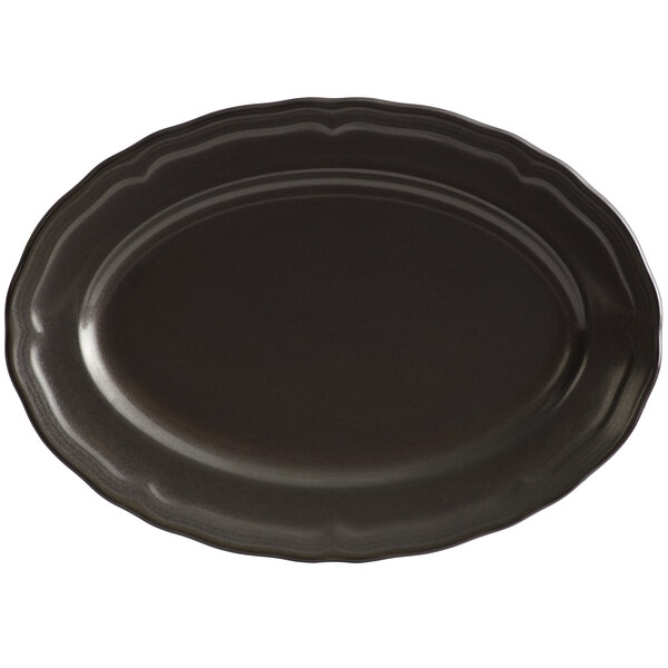 An Acopa Condesa matte black scalloped platter on a table.