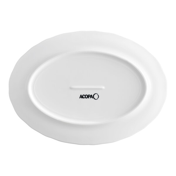 A white oval porcelain platter with a scalloped wide rim and the Acopa logo on the bottom.