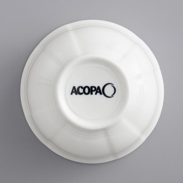 A white Acopa porcelain bouillon cup with scalloped edges.