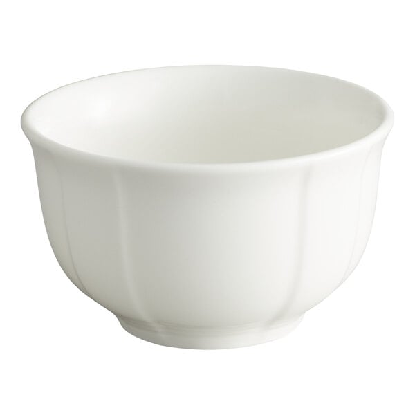 A white scalloped porcelain bouillon cup.