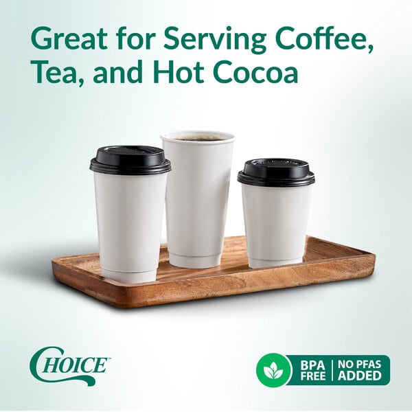 A set of three white double wall paper hot cups with black lids displayed on a wooden tray.