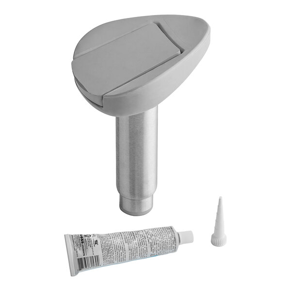 A white plastic Kason toilet jack with a tube of glue.