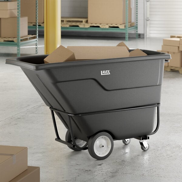 A black heavy-duty tilt truck or trash cart with a 1 cubic yard capacity, loaded with cardboard boxes.