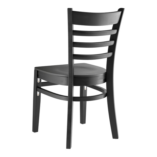 A Lancaster Table & Seating black wooden chair with a wooden ladder back and black seat.