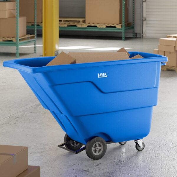 A blue Lavex 1 cubic yard light-duty tilt truck or trash cart with an 850 lb. capacity, shown in a warehouse setting with cardboard boxes inside.
