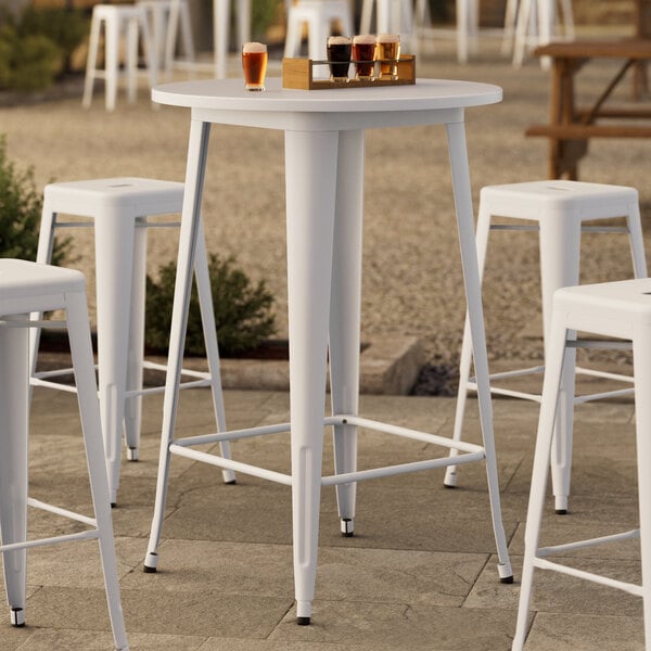 A Lancaster Table & Seating white bar table with stools.