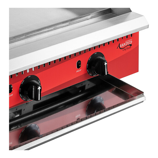 An Avantco 36" Countertop Gas Griddle with thermostatic controls on a counter in a professional kitchen.