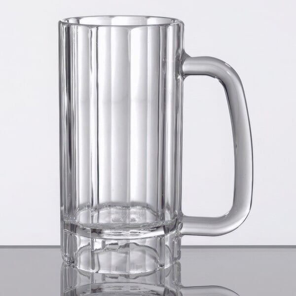 A clear plastic beer mug with a handle.