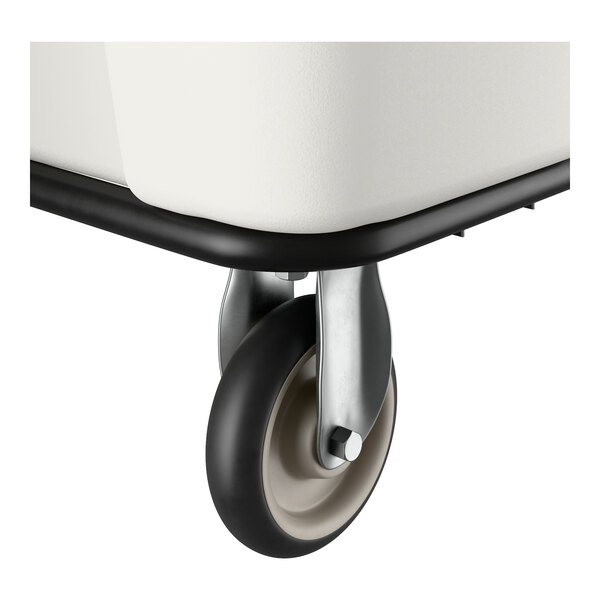 A close-up of a caster wheel attached to the bottom of a white leakproof cube truck.