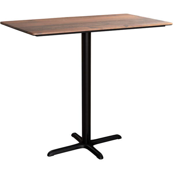 A Lancaster Table & Seating rectangular bar height table with a textured wooden top and a black cross base.