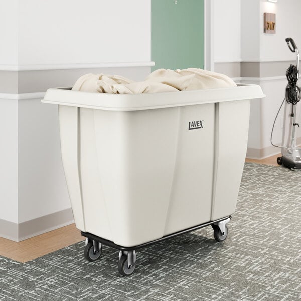 A large white cube truck with a 12 cubic foot capacity, designed for transporting laundry or materials, shown partially filled and on wheels.