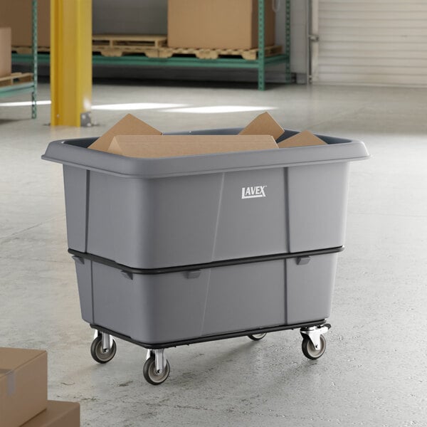 A large gray Lavex cube truck with a 20 cubic foot capacity and wheels, used for transporting materials in industrial settings.