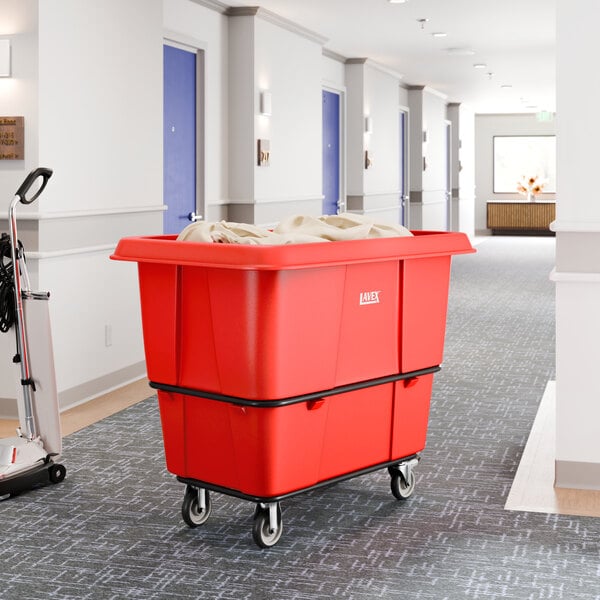 A large red leakproof cube truck with a 16 cubic foot capacity and wheels, used for transporting items such as laundry or supplies.