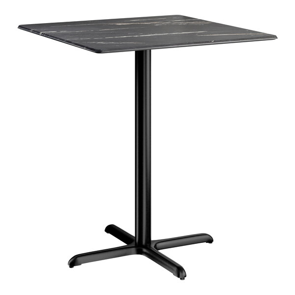 A square bar height table with a smooth dark finish and a black cross base plate.