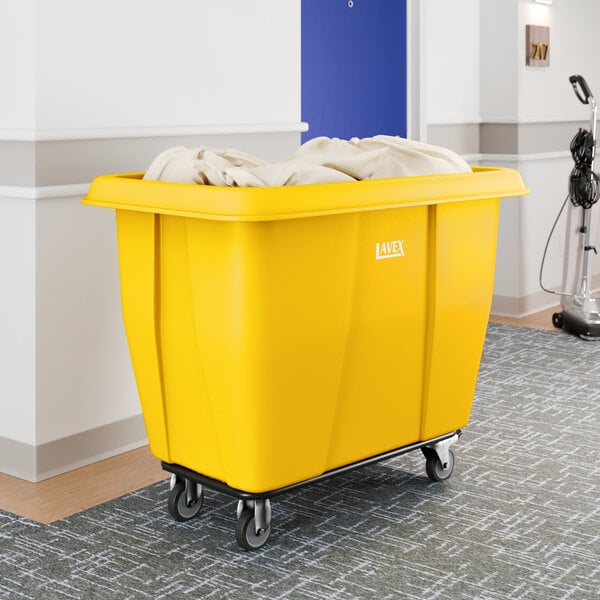A large yellow Lavex cube truck with a 12 cubic foot capacity, used for transporting items such as laundry.