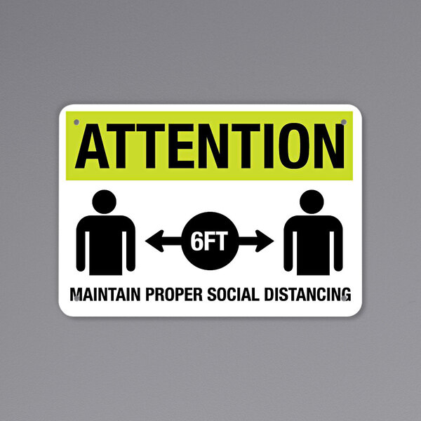 A black and yellow aluminum sign that says "Attention Maintain Proper Social Distancing" with images.