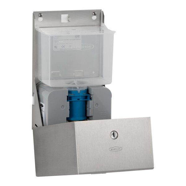 A stainless steel wall-mounted dispenser with an open front panel revealing an internal soap container and dispensing mechanism.