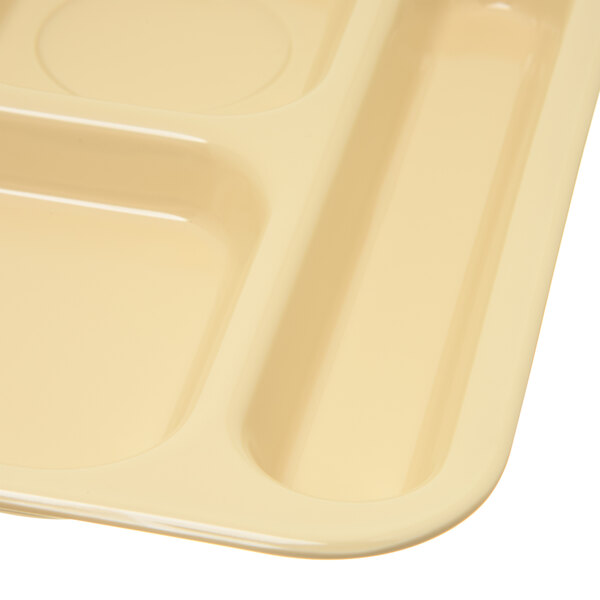 A white Carlisle 6 compartment tray with a tan surface.