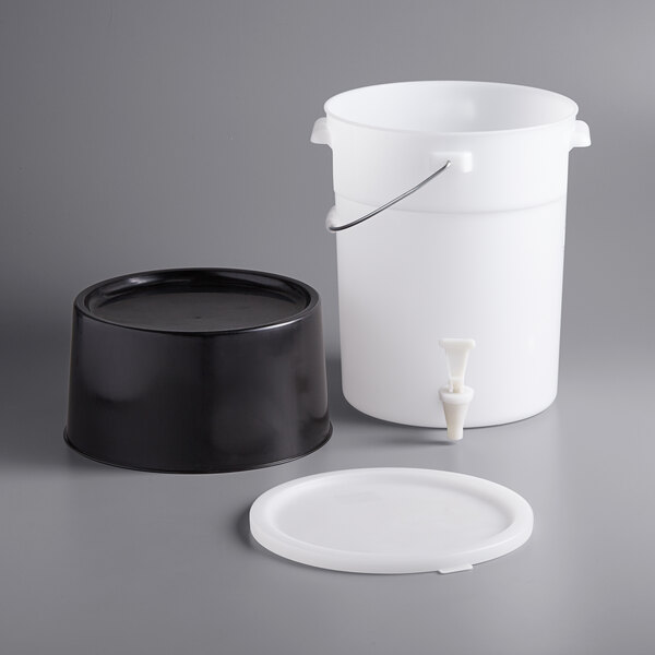 A white round plastic dispenser with a black base and labels.