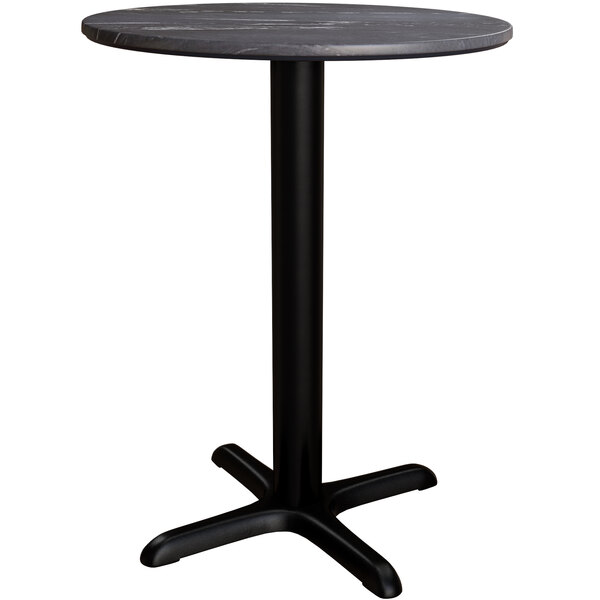 A round Lancaster Table & Seating dining height table with a black metal cross base.