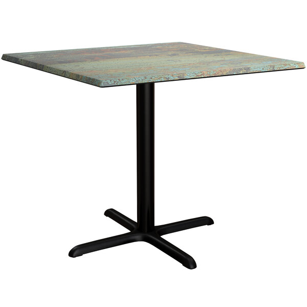 A Lancaster Table & Seating square dining table with a textured metal top and base.