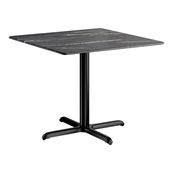 A square standard height table with a smooth black finish and a cross base plate.