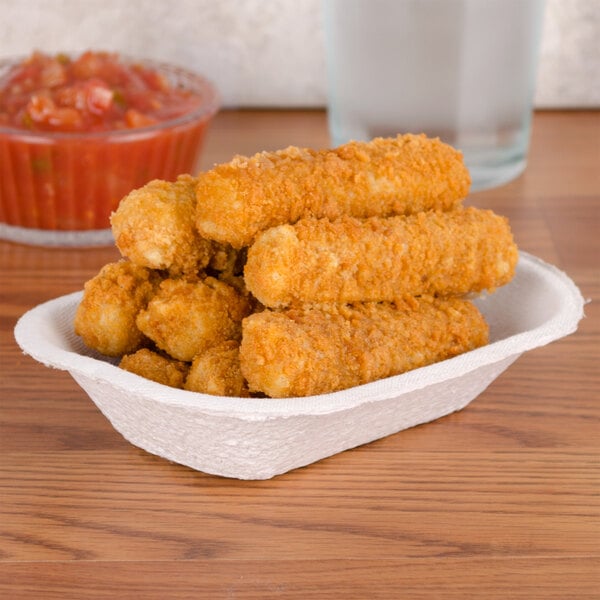 A rectangular paper food tray with fried chicken tenders and dipping sauce.