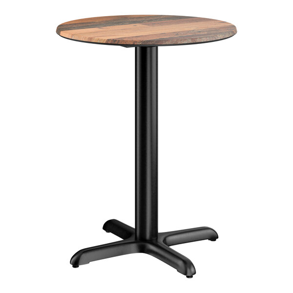 A round standard height table with a textured farmhouse finish and a black cross base plate.