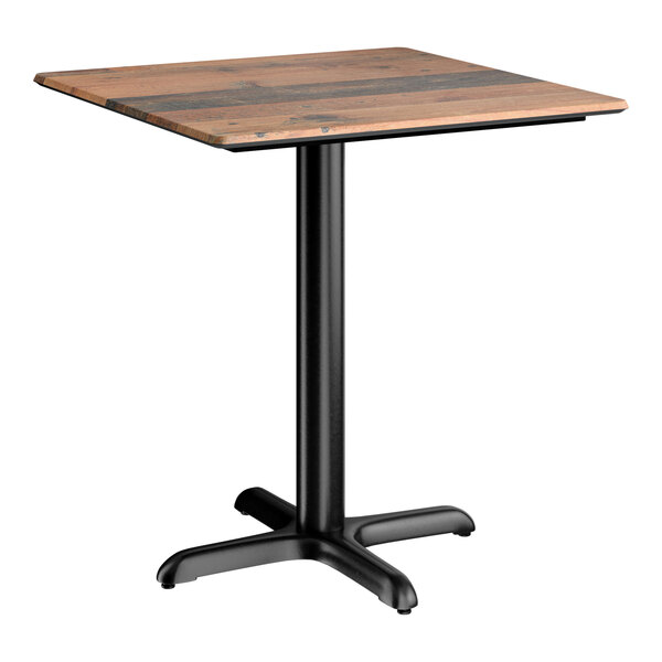 A square standard height table with a textured farmhouse finish top and a black cross base plate.