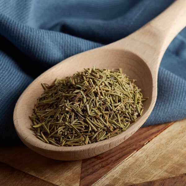 Rosemary leaves on a wooden spoon