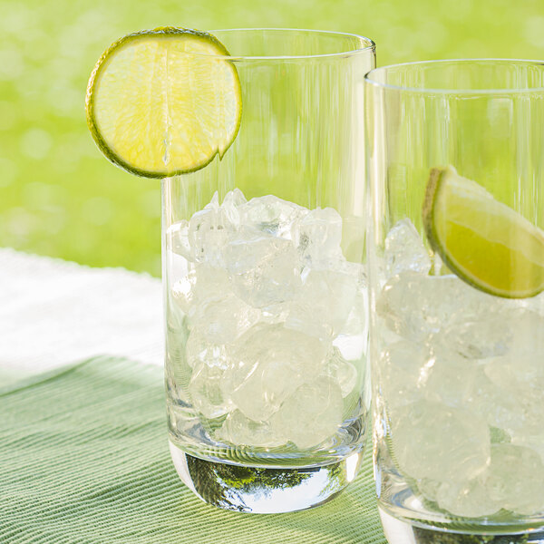 Two glasses of Cornelius ice with a lime wedge.