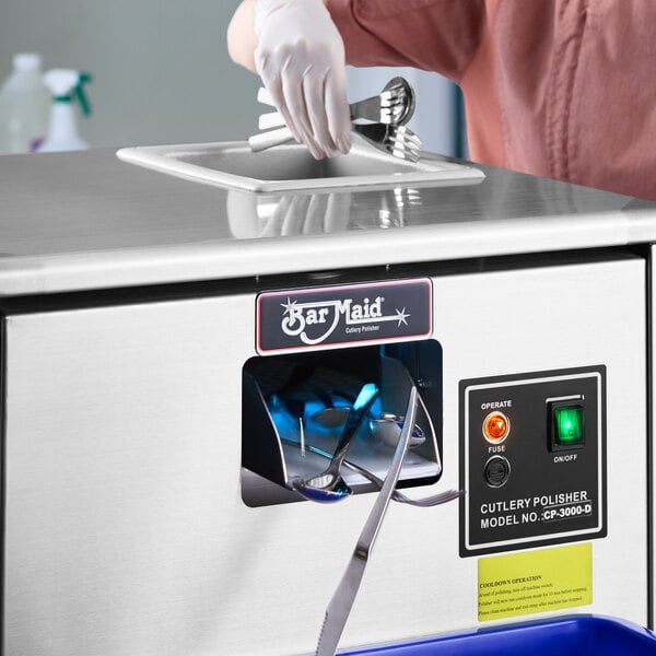 A Bar Maid CP-3000 cutlery dryer and polisher machine with utensils being inserted for cleaning.