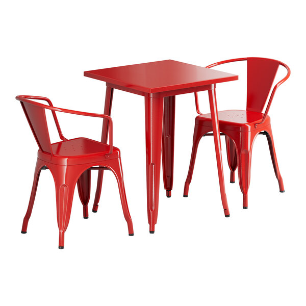 A red Lancaster Table & Seating outdoor table and two arm chairs.